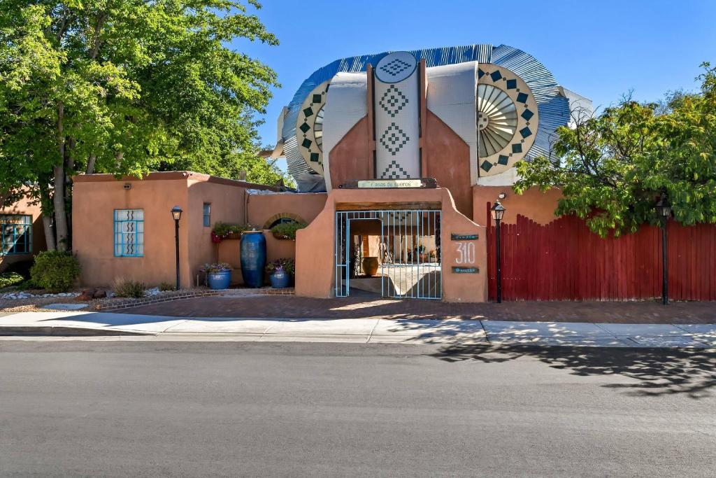 a building with a sign on the front of it at Casas de Suenos Old Town Historic Inn, an Ascend Collection Hotel in Albuquerque