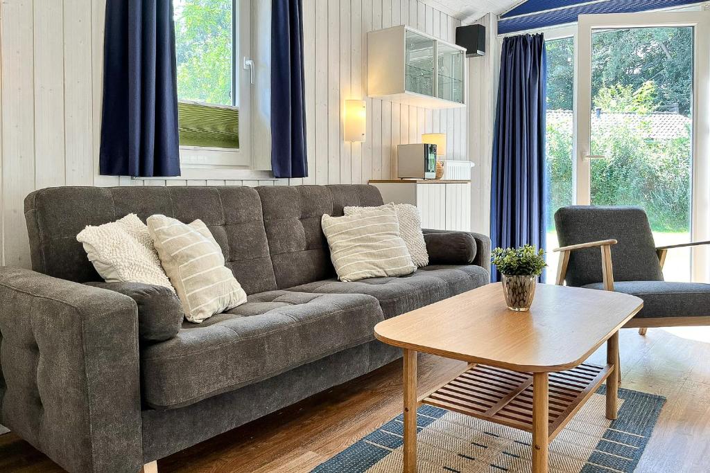 a living room with a couch and a table at Schatzkiste - Dorf Ferienhaus 4a in Priwall