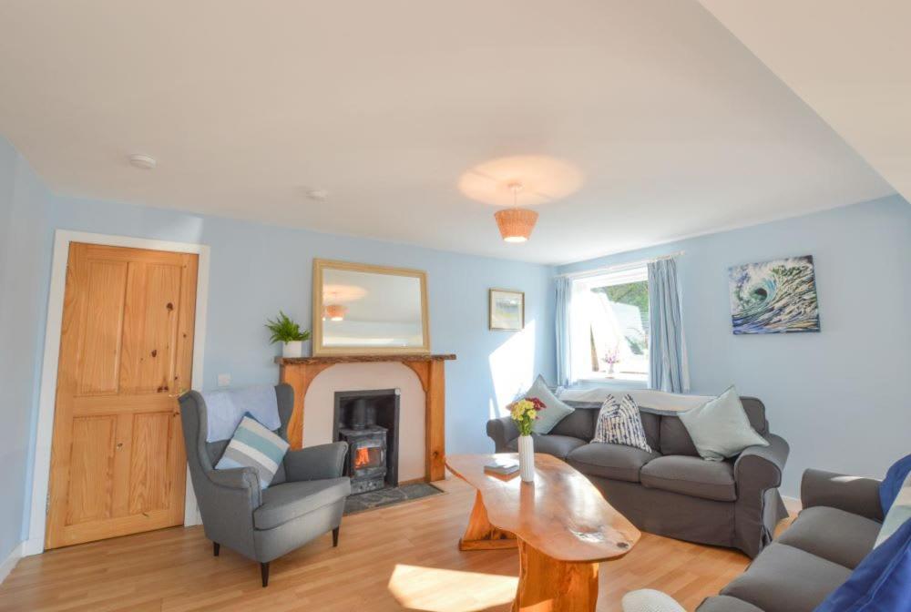 a living room with a couch and a fireplace at Stunning Coastal Home - Garden, Views, Pet Friendly in Connel