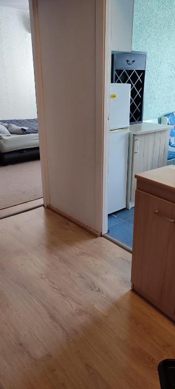 an empty room with a kitchen and a refrigerator at CheapStayVilnius in Vilnius