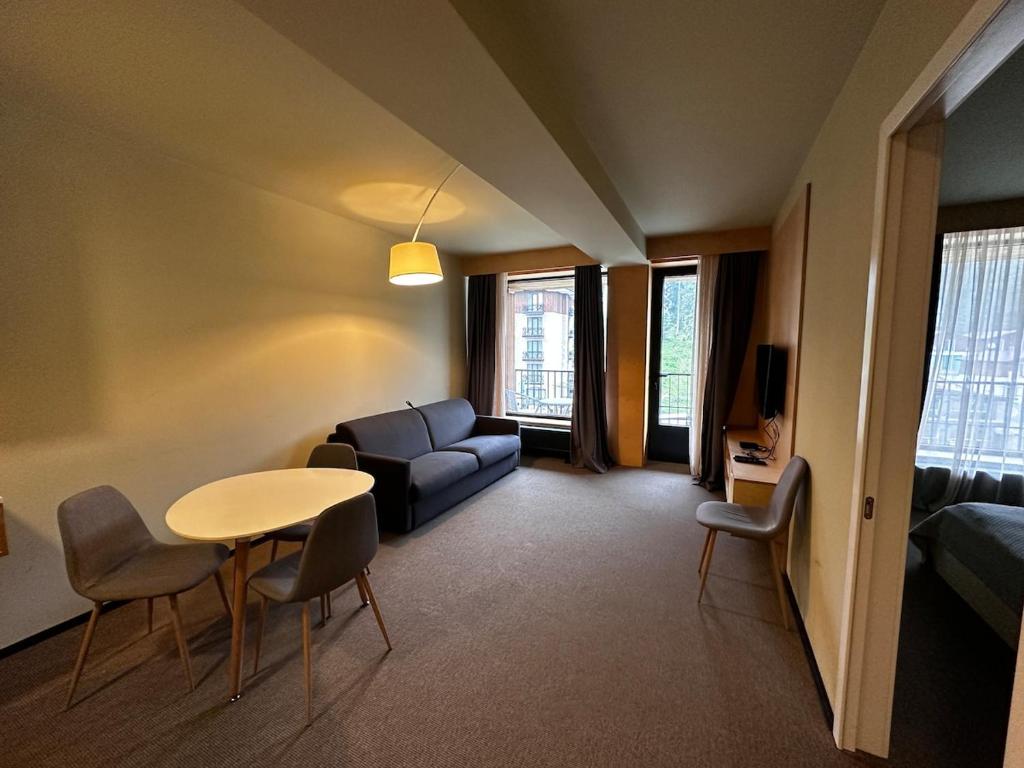 a living room with a couch and a table at The 4th Floor Vista in front of Kokhta in Bakuriani