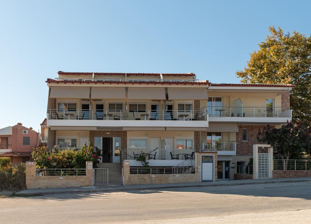 an apartment building with balconies on a street at Vila Sofia in Nikiti