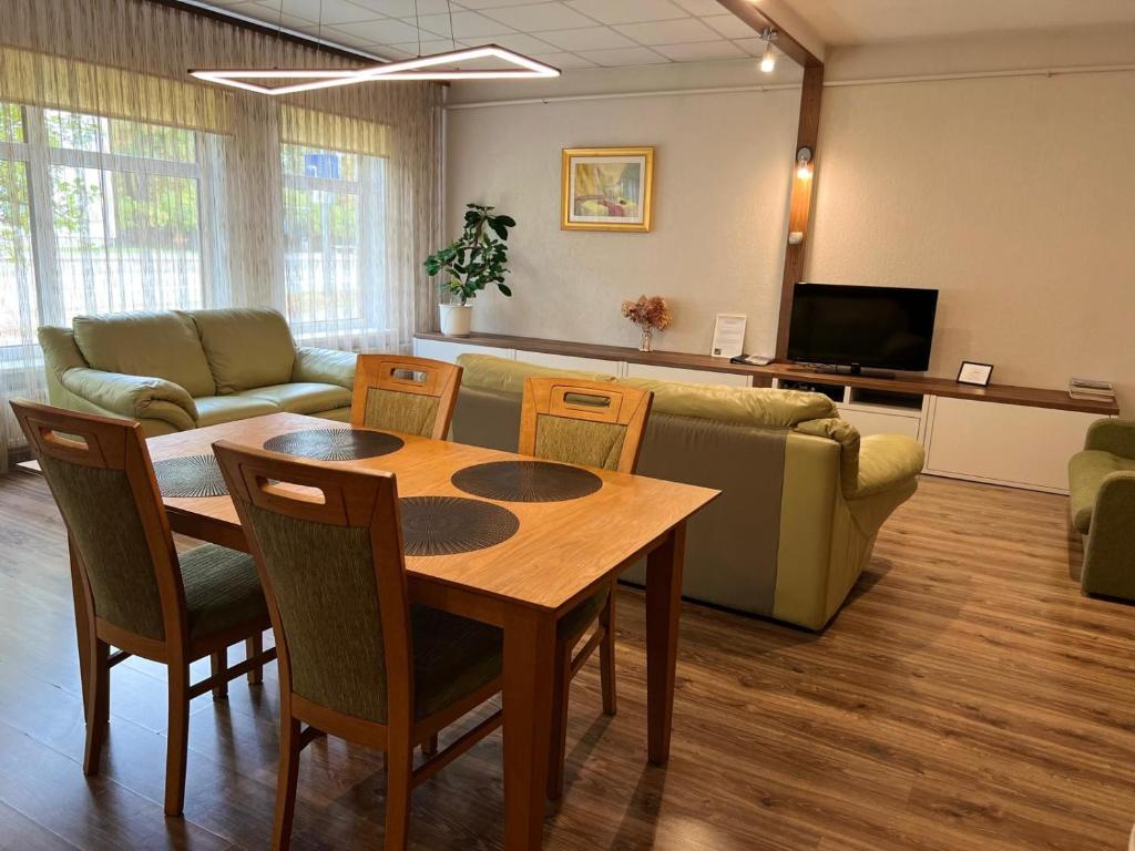 a living room with a table and a couch at RIGA street Apartment 54 entire house in Valmiera