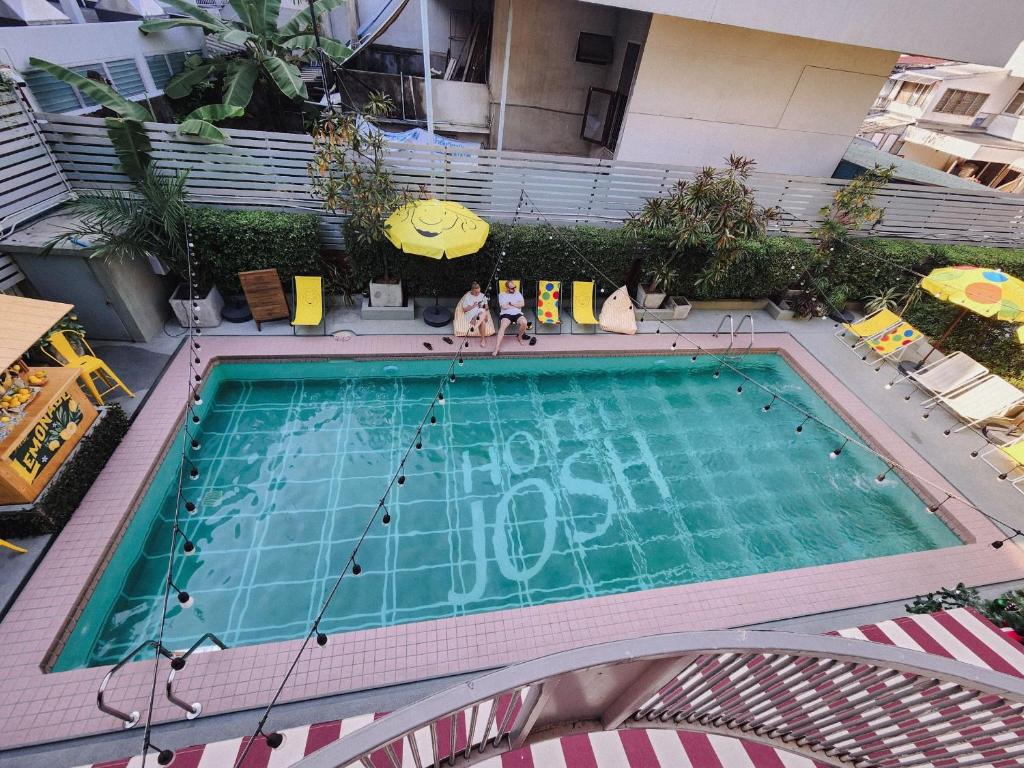 an overhead view of a swimming pool in a building at Josh Hotel in Bangkok