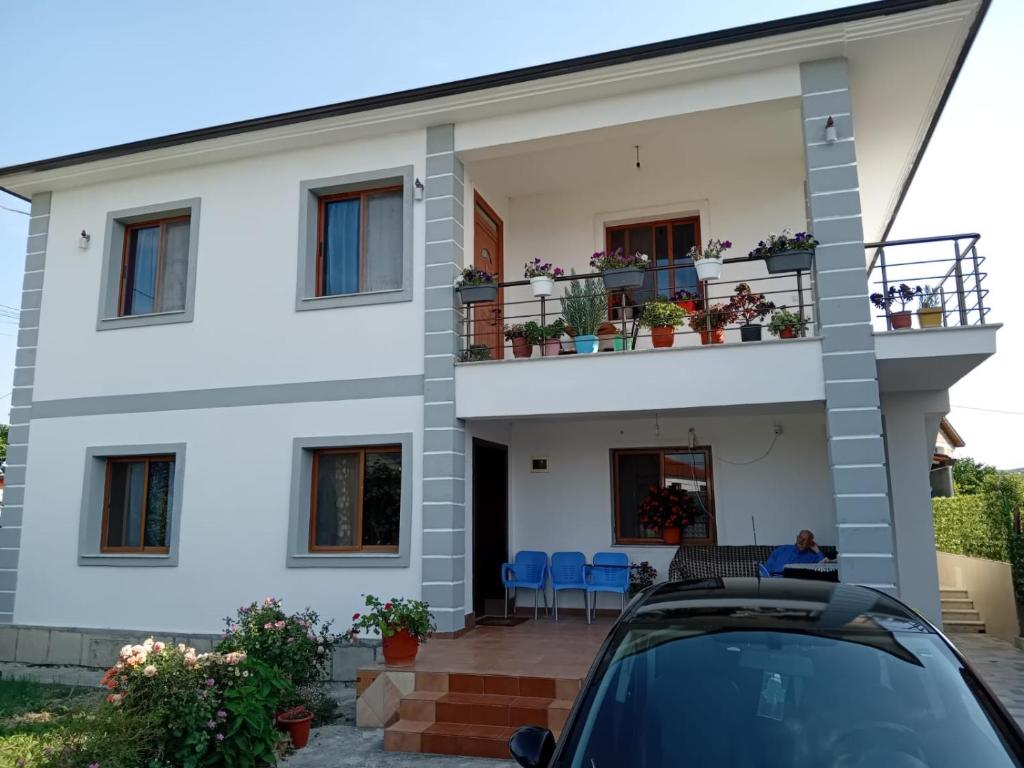 a house with a car parked in front of it at Villa GJOKA in Berat