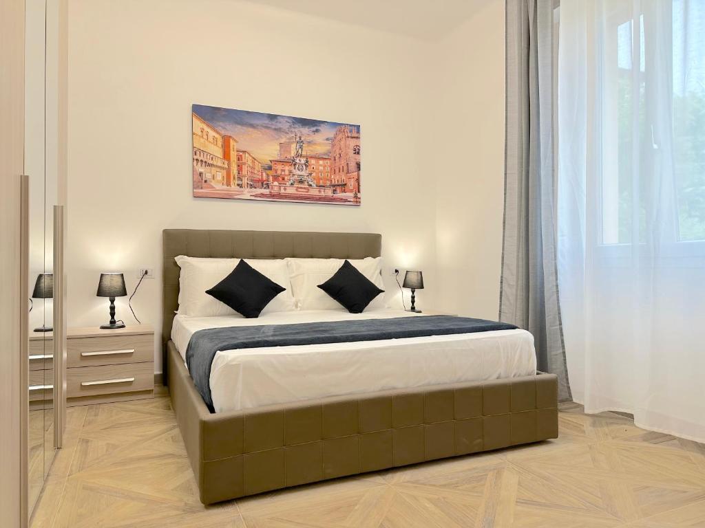 a bedroom with a bed and a painting on the wall at Amelia House in Bologna
