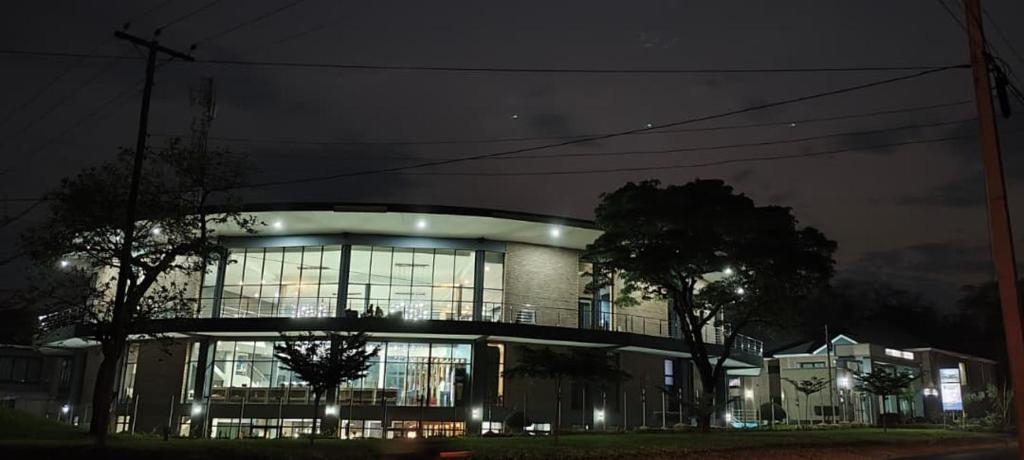 a large building with lights on at night at Lifestyle Boutique Hotel in Lilongwe