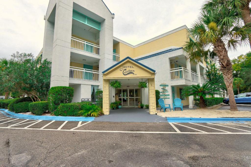 a hotel with a parking lot in front of it at Hotel Carolina - Standard King Room in Hilton Head Island