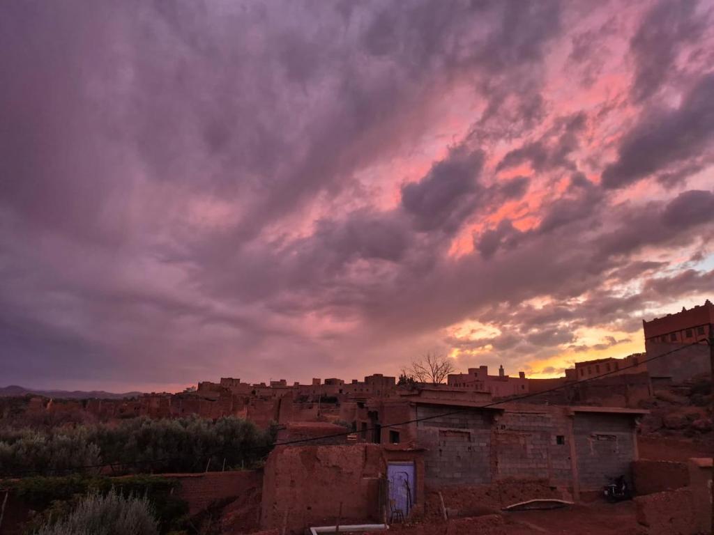 a cloudy sky above a city with buildings at Dar Mayssa Rose in Zawyat