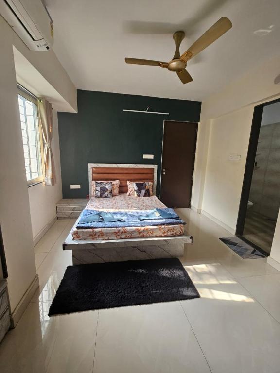 a bedroom with a bed and a ceiling fan at StayGinie Baner in Pune