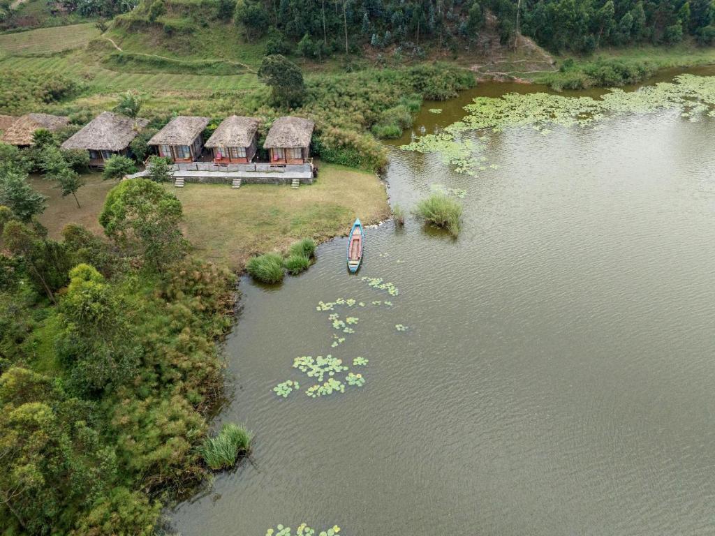 an aerial view of a house on a lake at Lake Chahafi Resort in Kisoro
