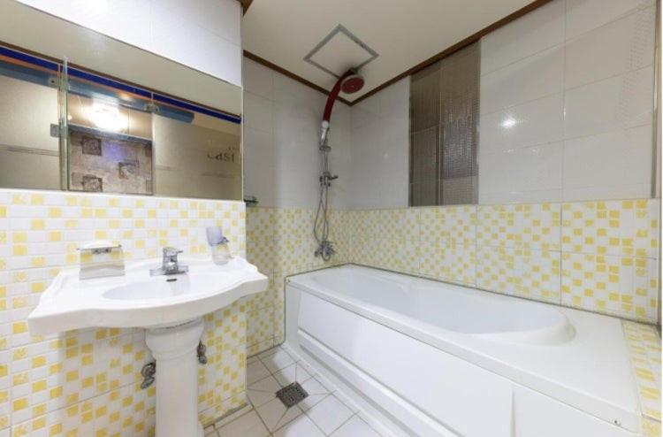 a bathroom with a sink and a bath tub at 전주 캐슬모텔 