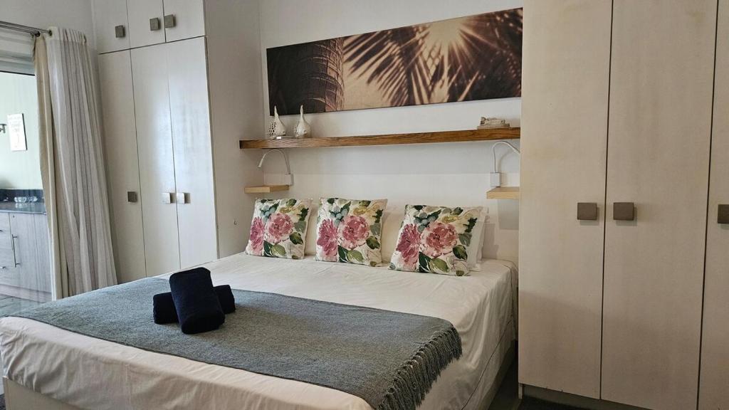 ein Schlafzimmer mit einem Bett, auf dem eine schwarze Tasche liegt in der Unterkunft Family Retreat - Pool - Gym - BBQ - Walk to Beach in Cap Malheureux