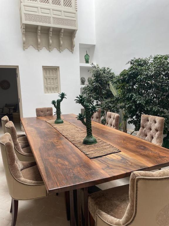 a wooden table with bonsai trees on top of it at Riad 4 chambres, Piscine chauffée, Petit déjeuner inclus in Marrakesh