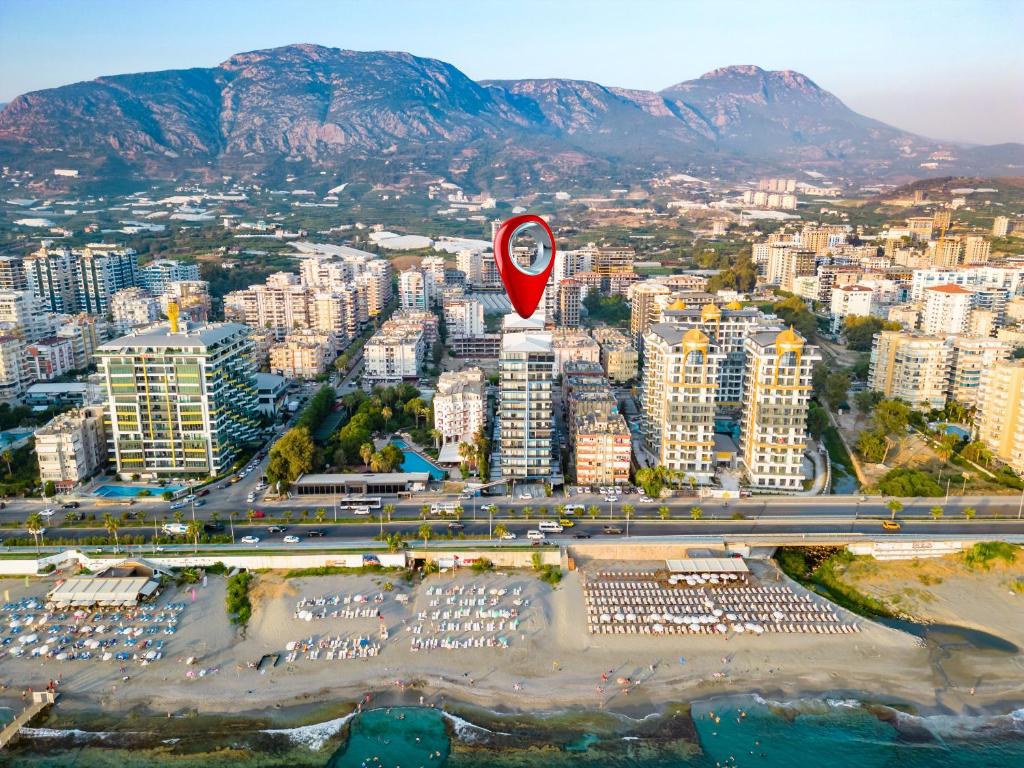 an aerial view of a city with a red marker at The Blue Tide - 1 Bedroom Apartment - All Bills Included in Alanya