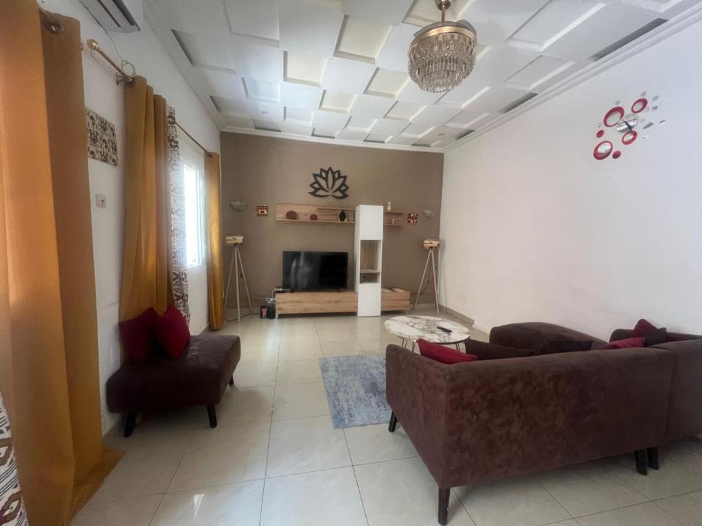 a living room with a couch and a chair at Mpita 2 in Pointe-Noire