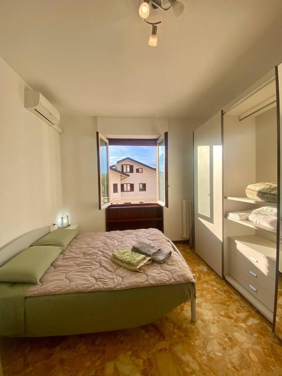a bedroom with a bed and a large window at Villa Ferrari - Park Monza F1 Circuit in Villasanta