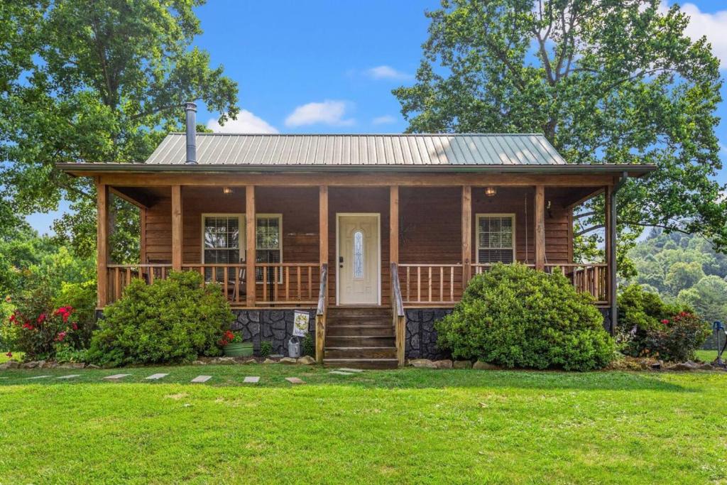 a wooden house with a porch and a lawn at Heavenly Hideaway - near Red River Gorge KY in Beattyville