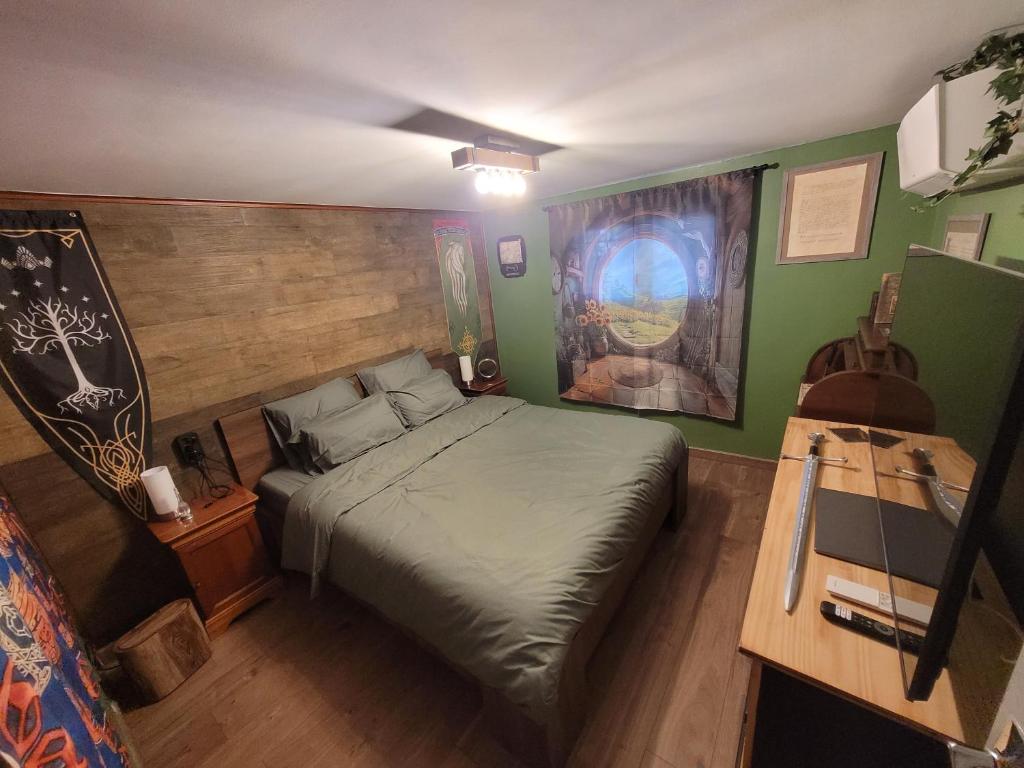 a bedroom with a bed in a room with green walls at La Comté à Blagnac in Blagnac