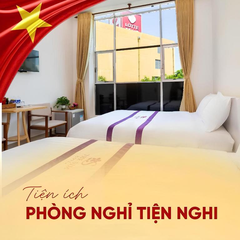 a hotel room with two beds and a window at The Sim Hotel Vung Tau in Vung Tau