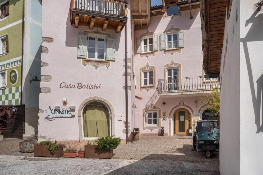 a building with a sign on the side of it at Casa Batistei Ribes in Molveno