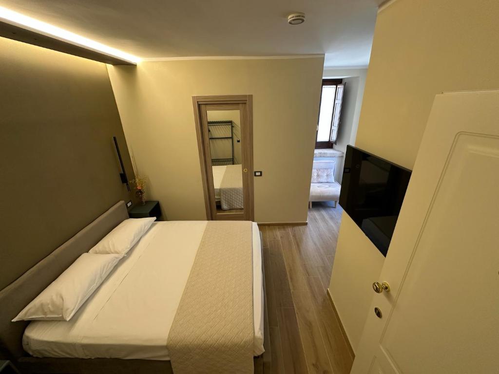 a bedroom with a bed and a flat screen tv at al Vico Bedrooms in Crotone