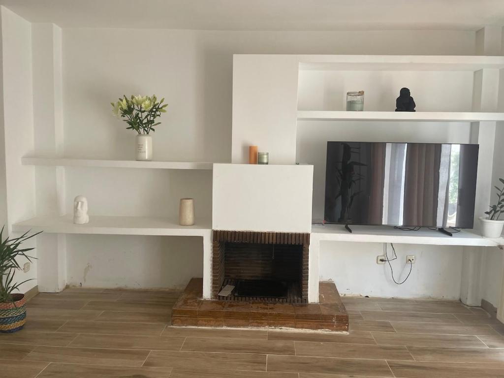 a living room with a tv and a fireplace at HABITACIÓN en chalet cerca Atocha in Madrid