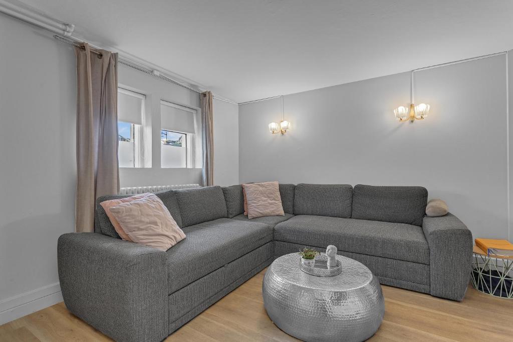 a living room with a couch and a table at Castle Inn Apartments - Downtown Keflavík in Keflavík