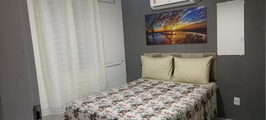 a bedroom with a bed and a painting on the wall at Casa de Jovan in Cayru