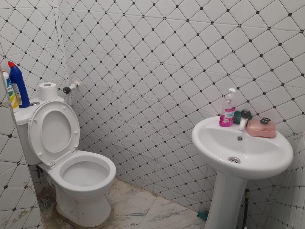 een badkamer met toilet en wastafel bij Mwembeni Abode in Bamburi