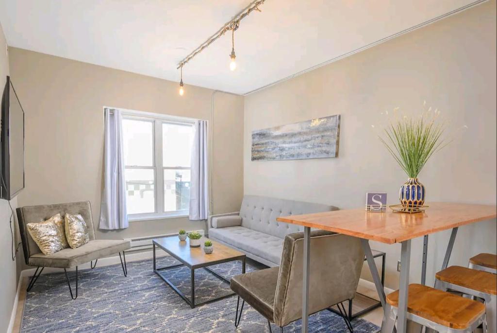 a living room with a couch and a table at Downtown 2 Bedroom Apartment in Appleton