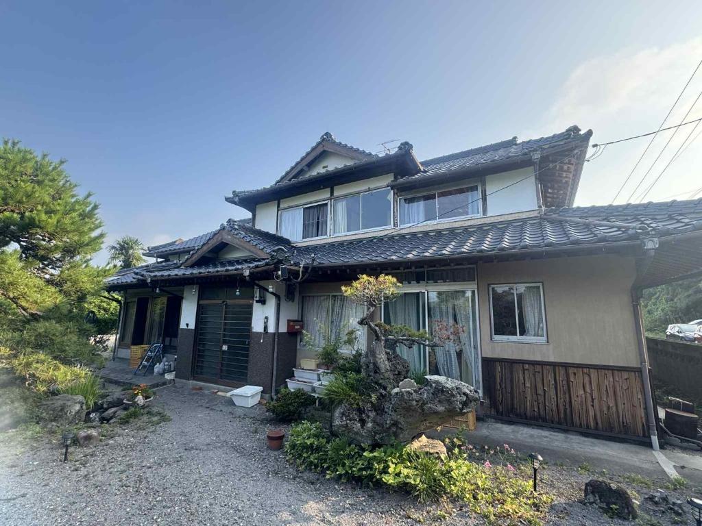 a house with a porch and a fence at くりのやかた in Kunisaki