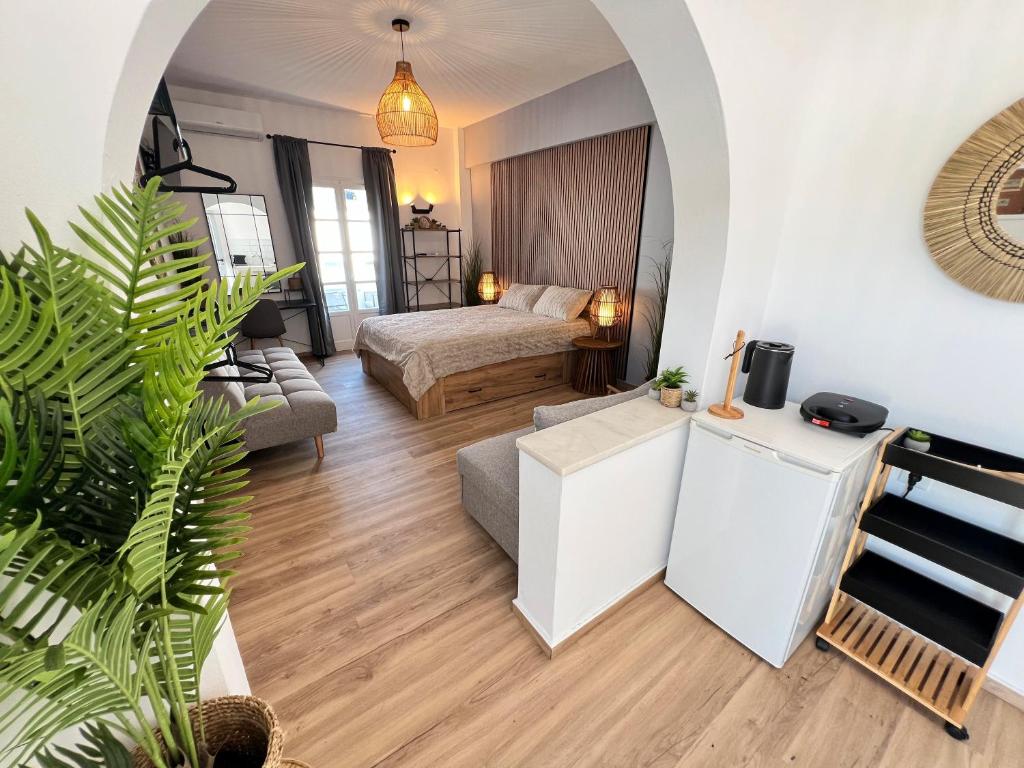 a living room with a bed and a couch at aeolian blu 1 in Parikia