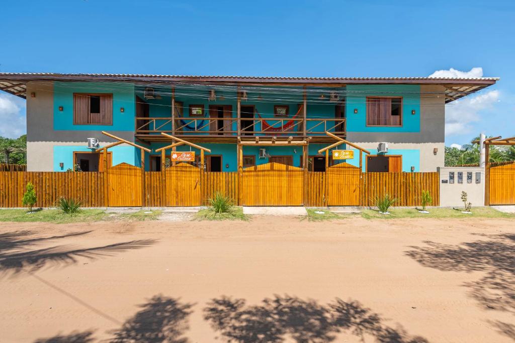 a blue house with a fence in front of it at Village das Estações in Marau