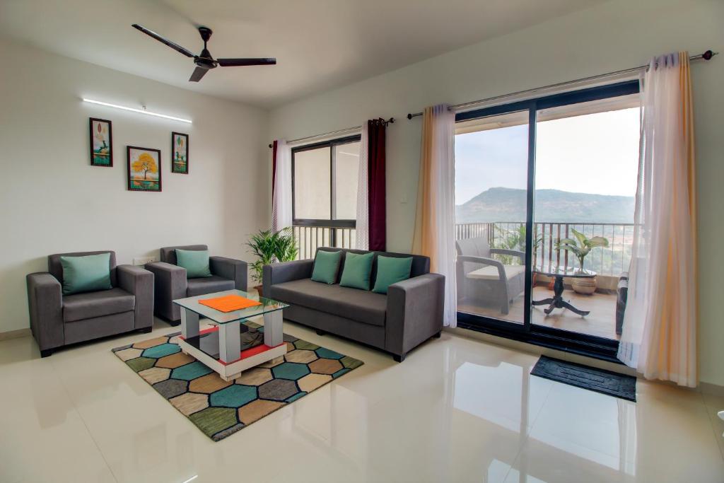 a living room with two couches and a table at VibeStayZ Kedar Hinjewadi in Hinjewadi