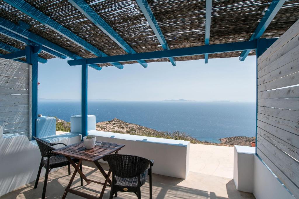 a patio with a table and chairs and the ocean at Mesaria Studio in Donoussa