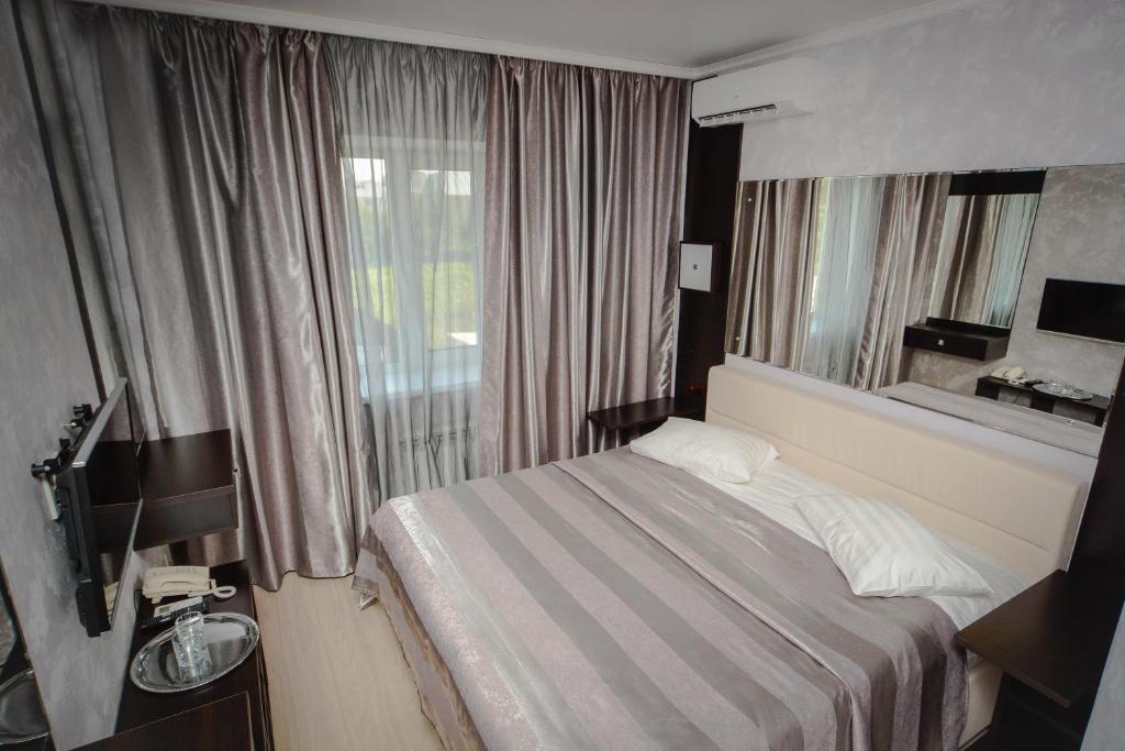 Кровать или кровати в номере Гостиница «Тет-а-Тет»