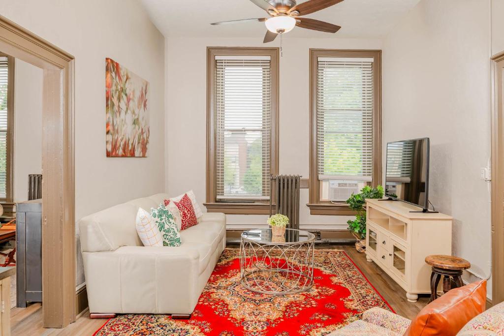 オシュコシュにあるLarge Luxury Downtown Loft - Walk to Everything Free Parkingの白いソファとテレビのあるリビングルーム