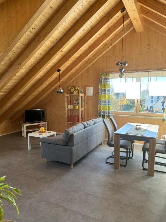 a living room with a couch and a table at Holzliebe mit Donaublick in Kaisheim