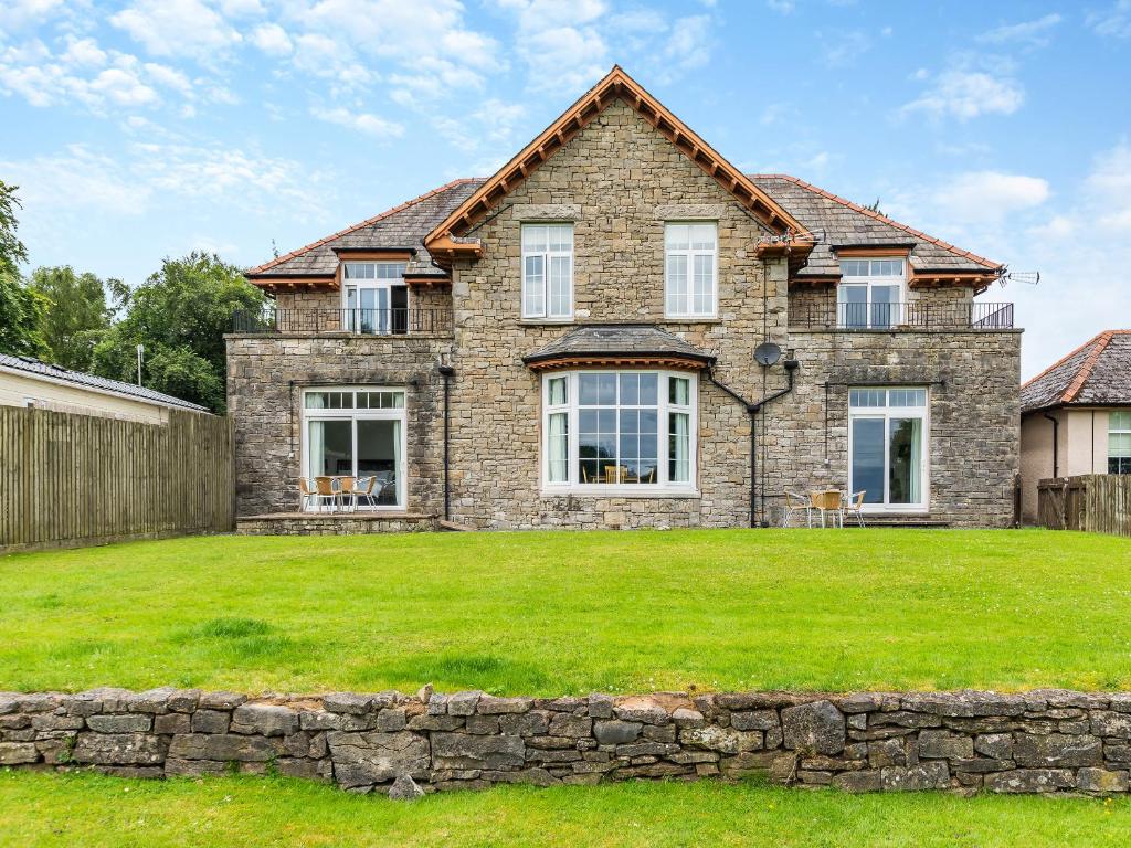 a large brick house with a grass yard at Silverdale Apartment in Lindale