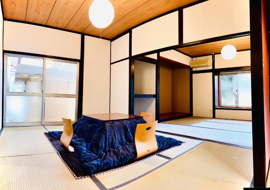 a room with a bed in the middle of it at Takemi no Yado - Vacation STAY 97130v in Yufuin