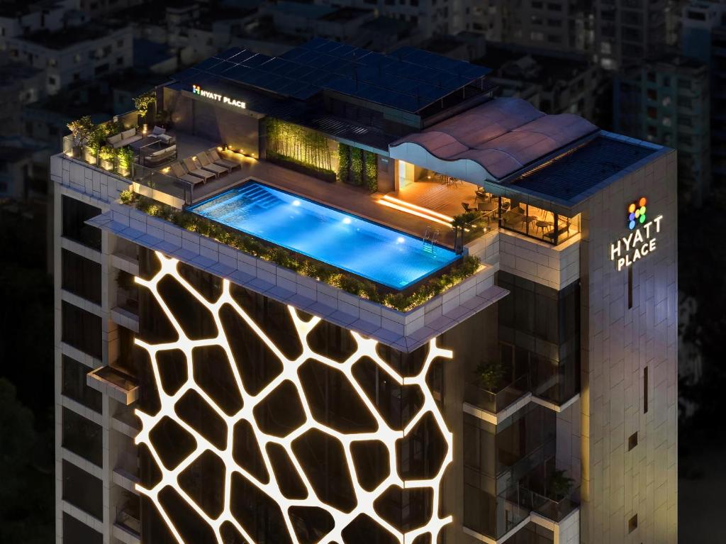 a rendering of a building with a swimming pool at Hyatt Place Dhaka Uttara in Dhaka