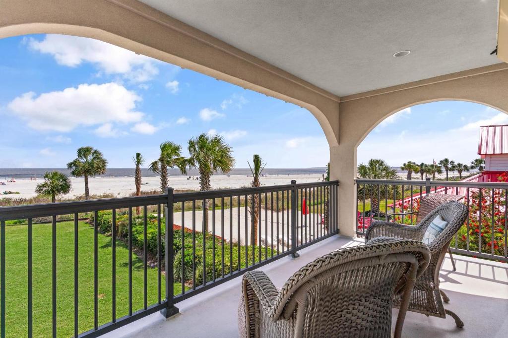 a balcony with chairs and a view of the beach at Ocean Front Escape - 1106 Beachview Dr in Demere Park