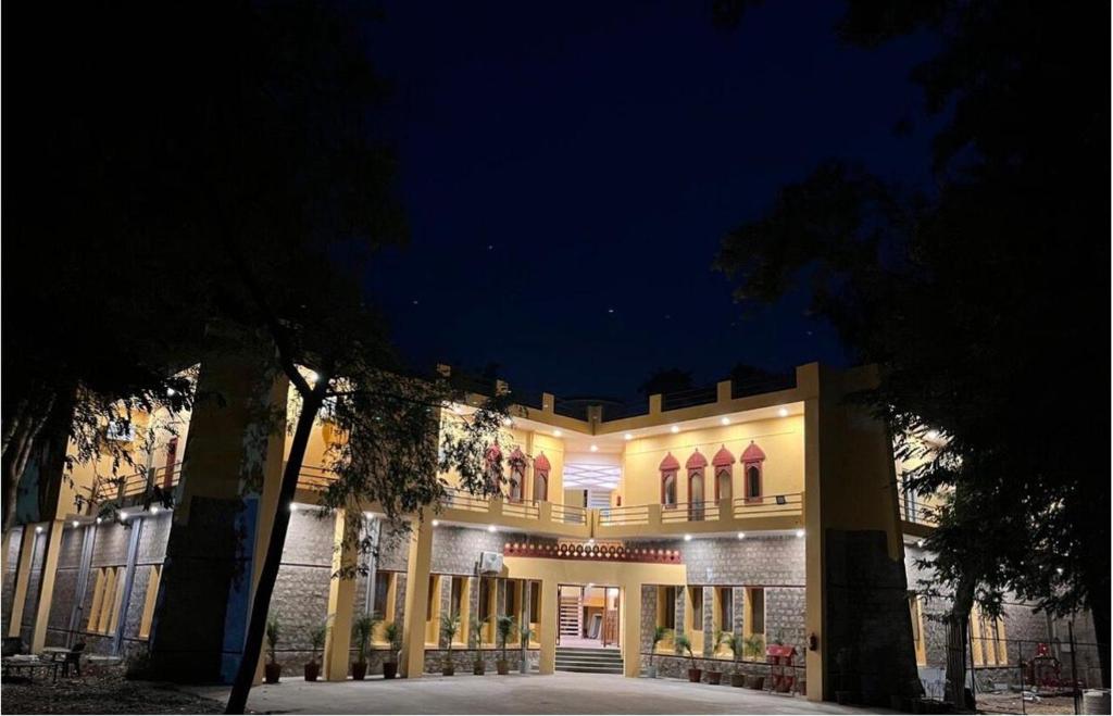 a large building with lights on it at night at Estherea Bagh Ranthambhore Tiger Territory in Sawāi Mādhopur