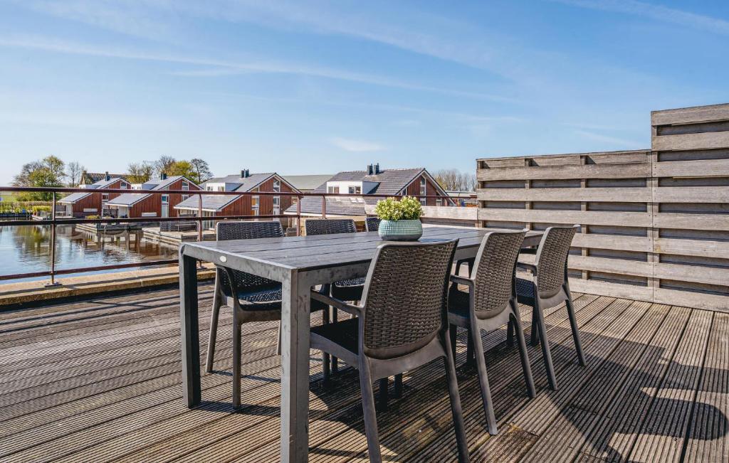 a table and chairs on the deck of a house at Oostergeest 3 6P in Uitgeest