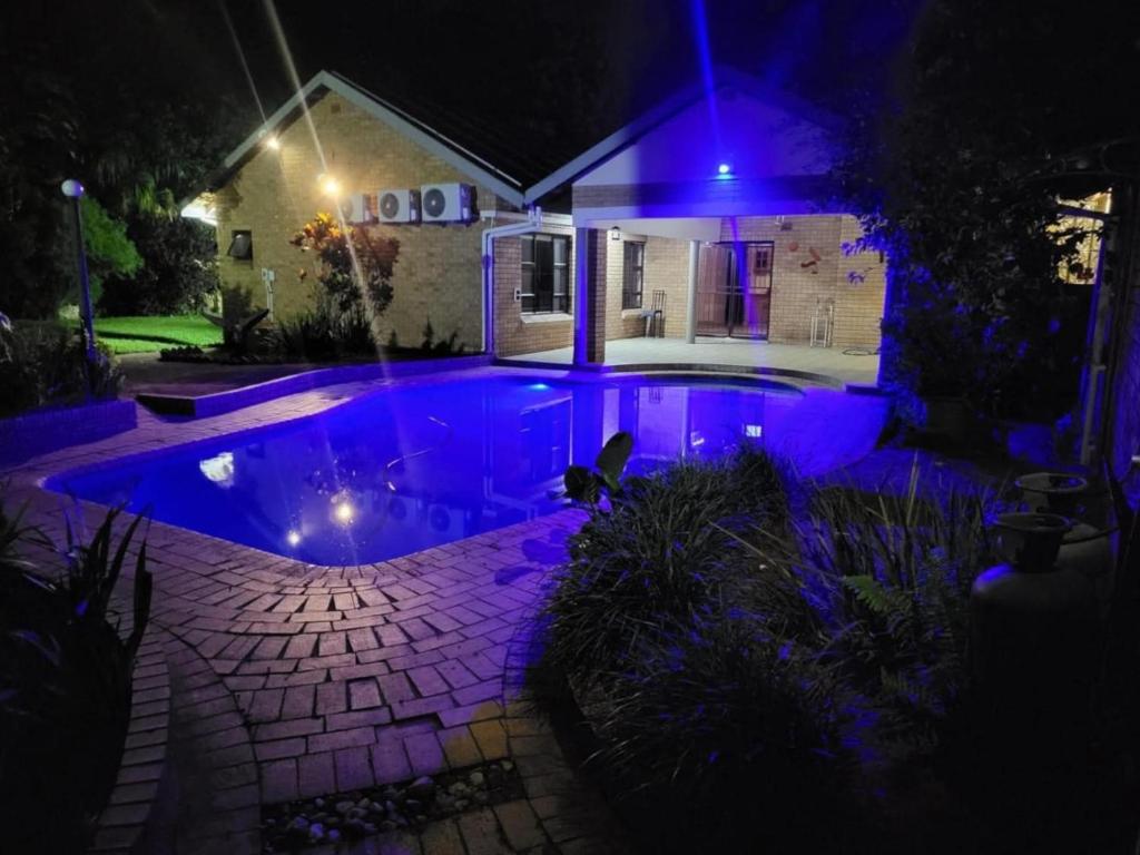 a house with a swimming pool at night at Happy Holiday Lodge in Meer en See