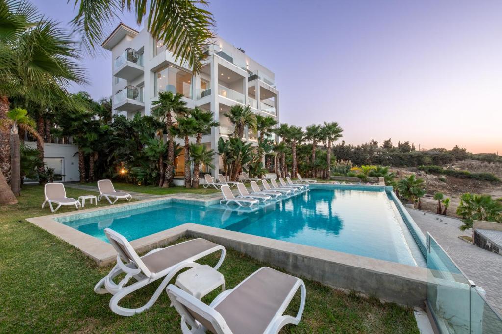 a resort with a swimming pool and lounge chairs at Le Tanger Résidence Hôtelière in Tangier