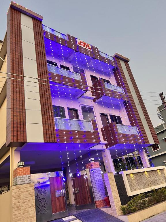 a building with purple lights on the side of it at Joshi Homestay in Dehradun
