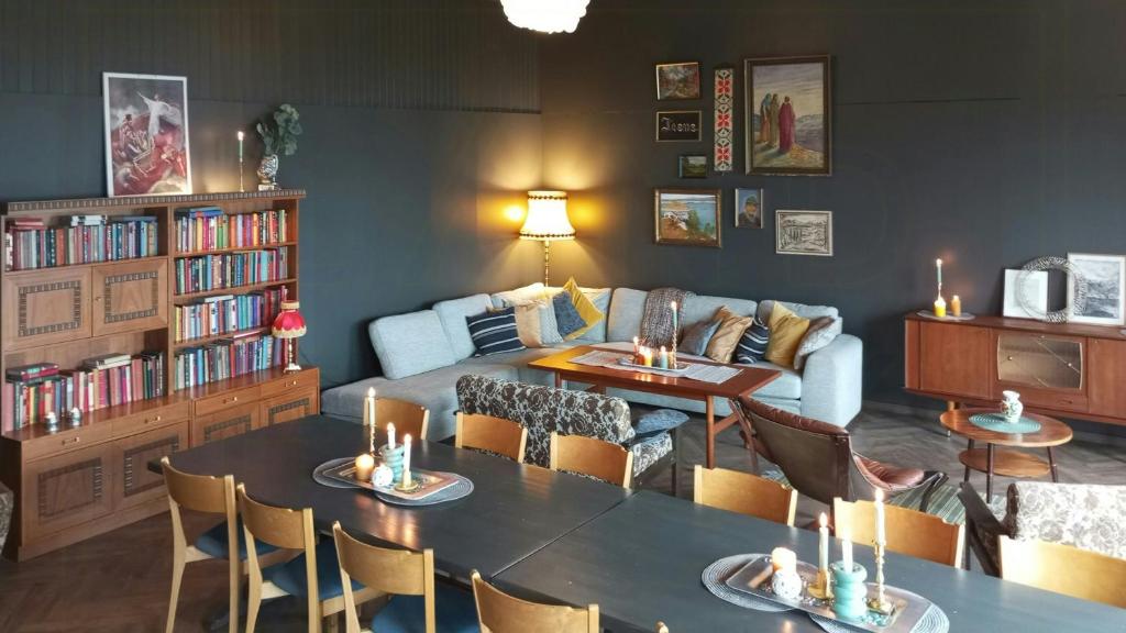 a living room with a table and a couch at Renovated Chapel With Fjord Views In Vågstranda in Reistad