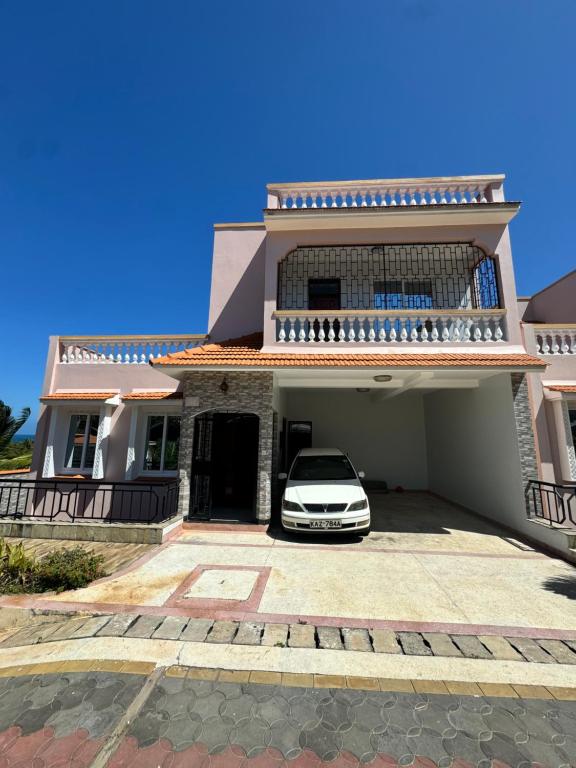 a car parked in front of a house at Shuja Ranches in Kilifi